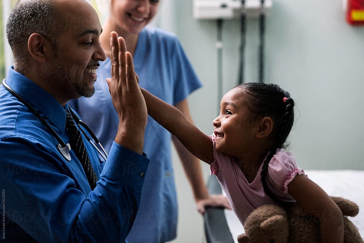 Doctor and young patient sharing a high five
